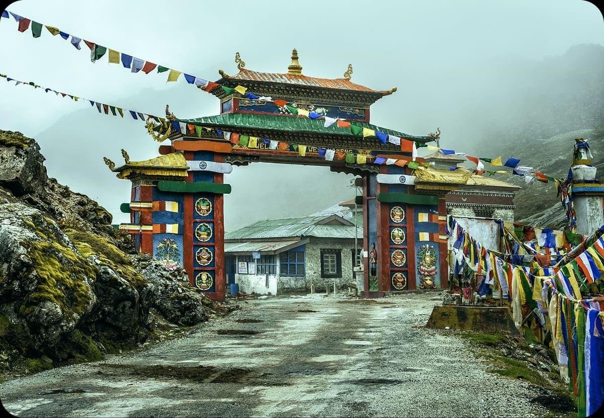 Traditional monastery gate decorated with prayer flags